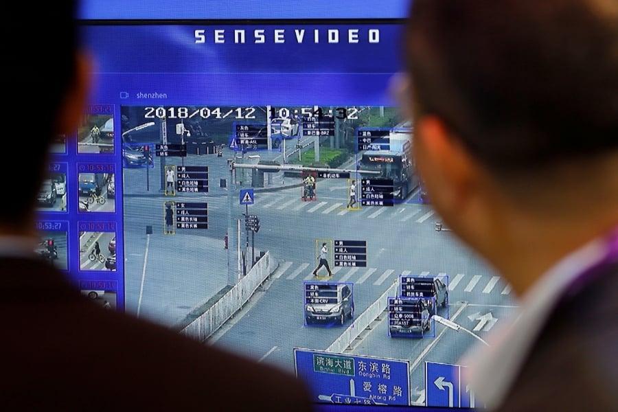 Visitors examining a monitor demonstrating traffic surveillance aided by artificial intelligence and facial recognition software at an exhibition in Beijing. People need to reinvent themselves to keep their skills relevant in an increasingly technology-dependent world. -Reuters